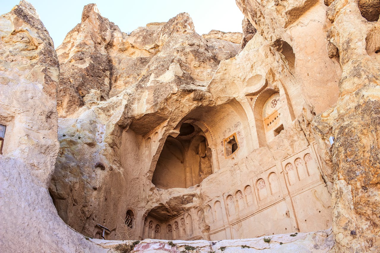 Explore the ancient cave church architecture in Cappadocia, carved into the natural rock formations.